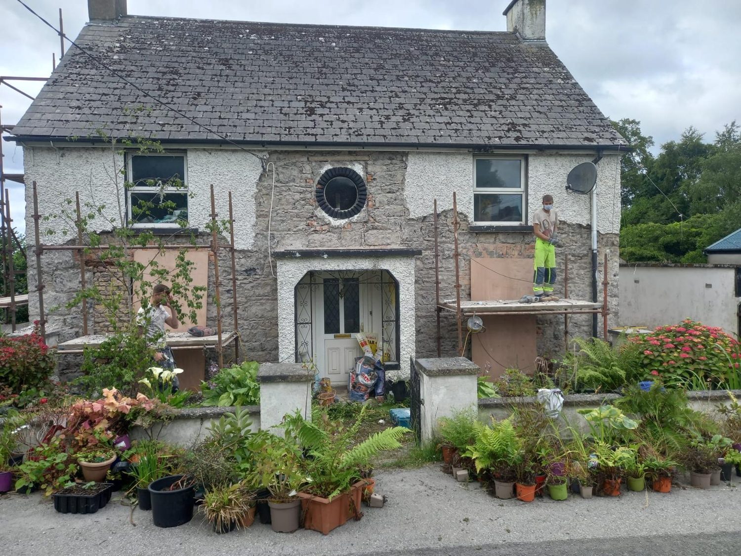 Cement dash being stripped off the front of a house in Mullingar, with the team on scaffold