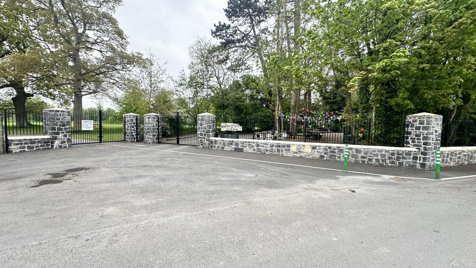 Grand natural limestone estate entrance with stone pillars and gates by L&A Building Experts