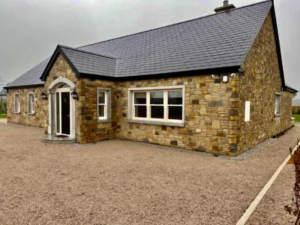 Professional stone cladding installation on Irish home exterior