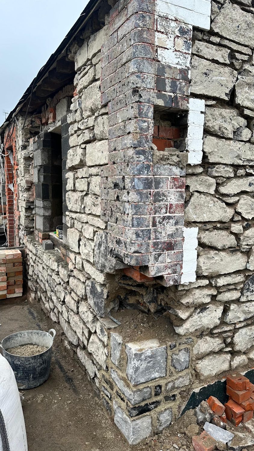 Swords cottage restoration — stone rebuilt and window openings formed