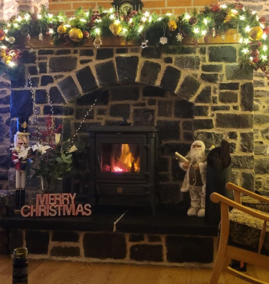 Hand-built stone fireplace with wood-burning stove in restored Swords cottage