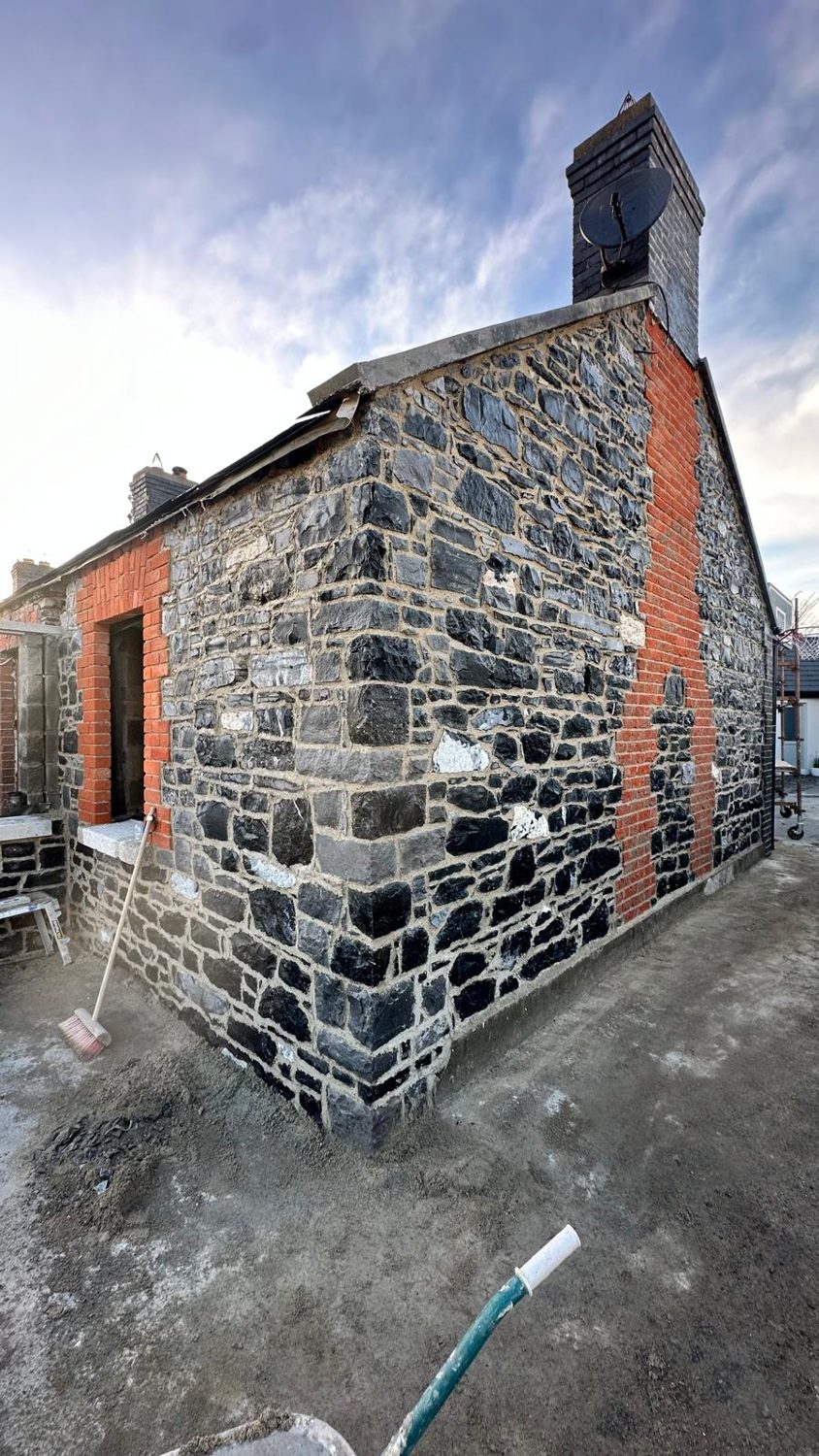 Swords cottage restoration — finished stone gable with brick chimney