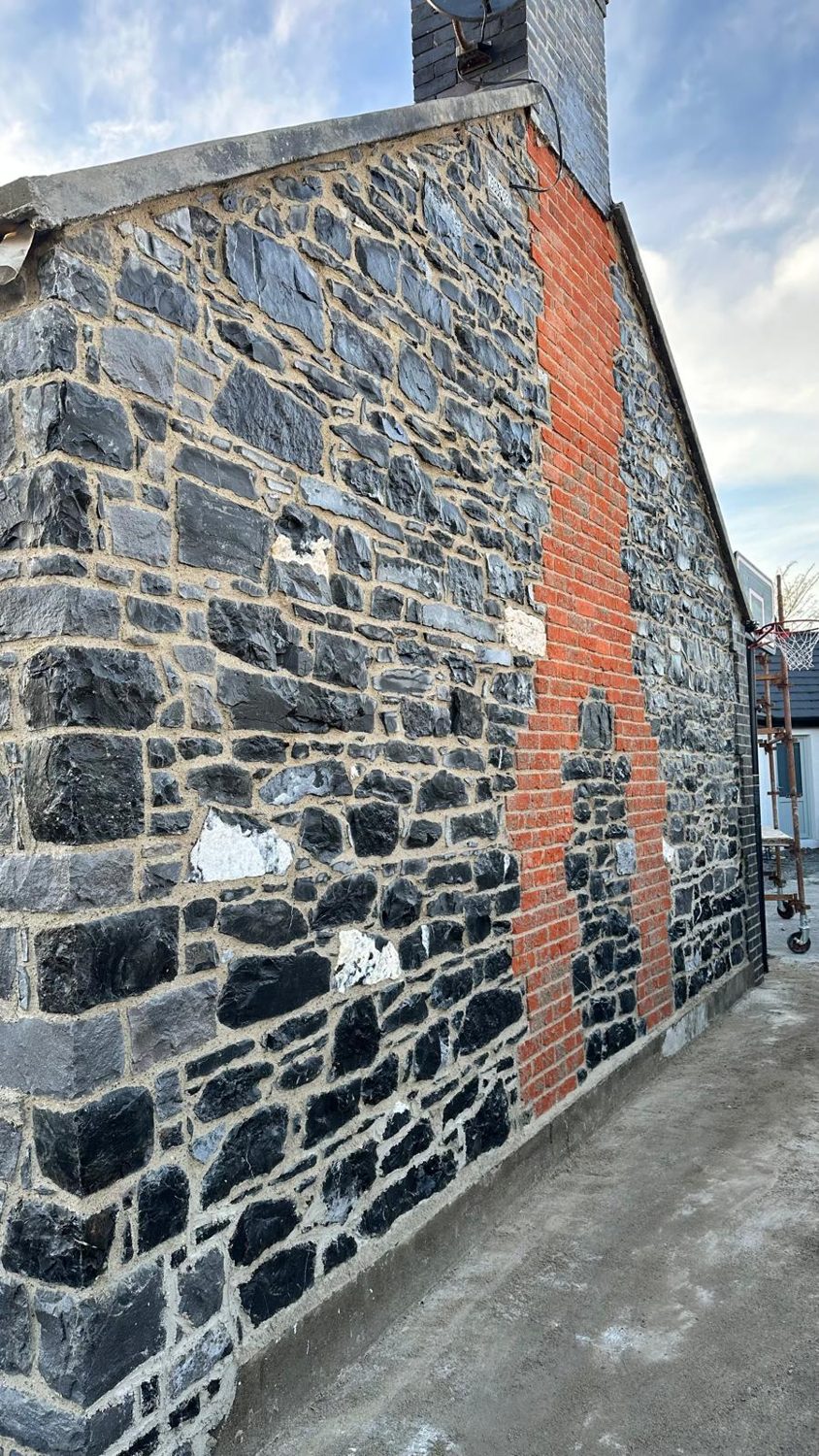 Stone cottage repointed in lime mortar with red-brick quoins, Swords Dublin