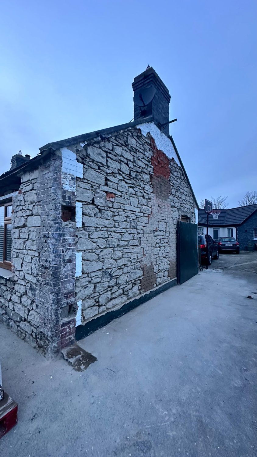 Swords cottage restoration — repointed stone gable and chimney
