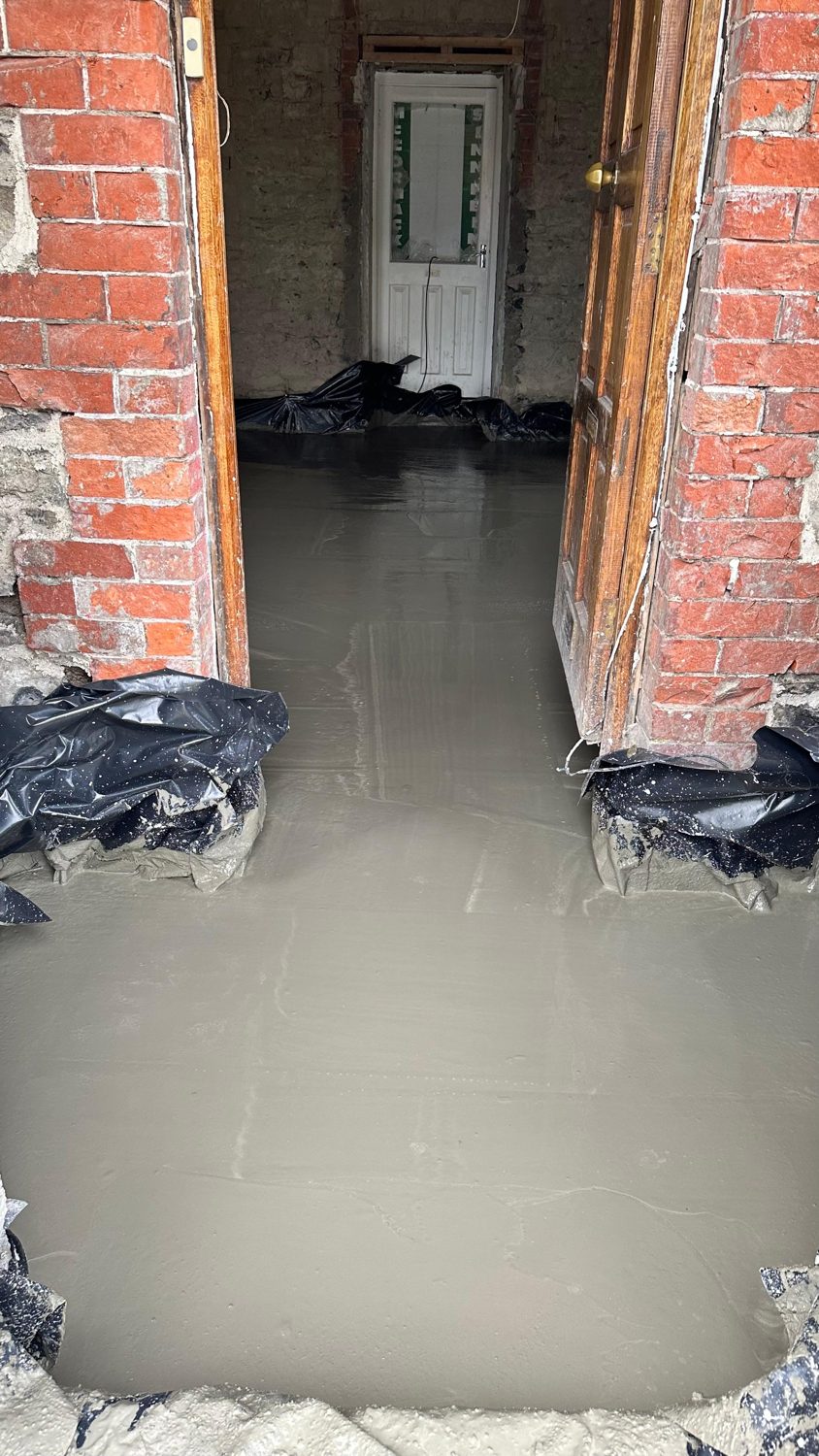 Swords cottage restoration — new floor with brick chimney breast