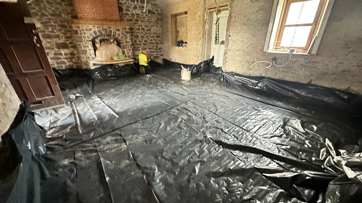 Swords cottage restoration — old fireplace opening in stone wall