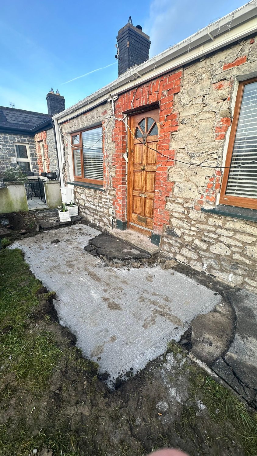 Swords cottage restoration — front with old cement render removed and new threshold laid