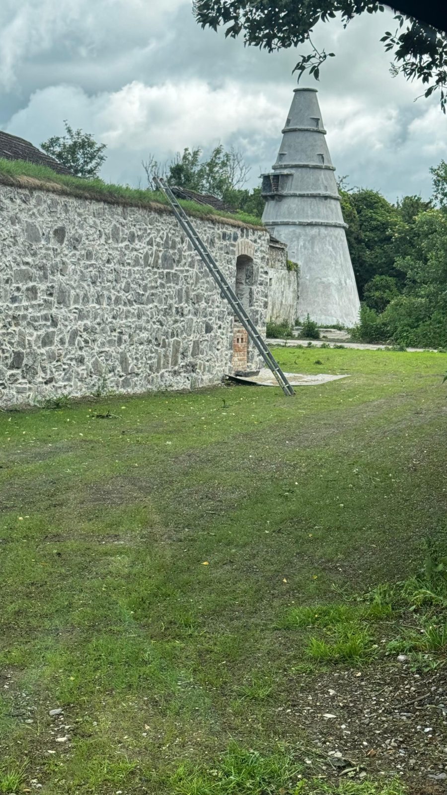 The Wonderful Barn Leixlip — rebuilt wall section with tower beyond, after